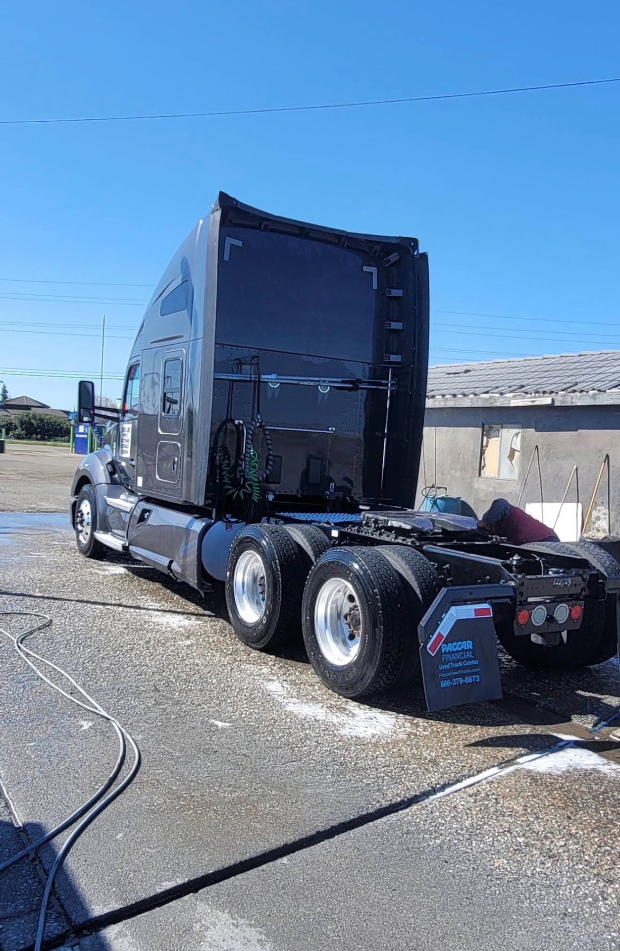 Silver Peterbilt semi truck rear wash