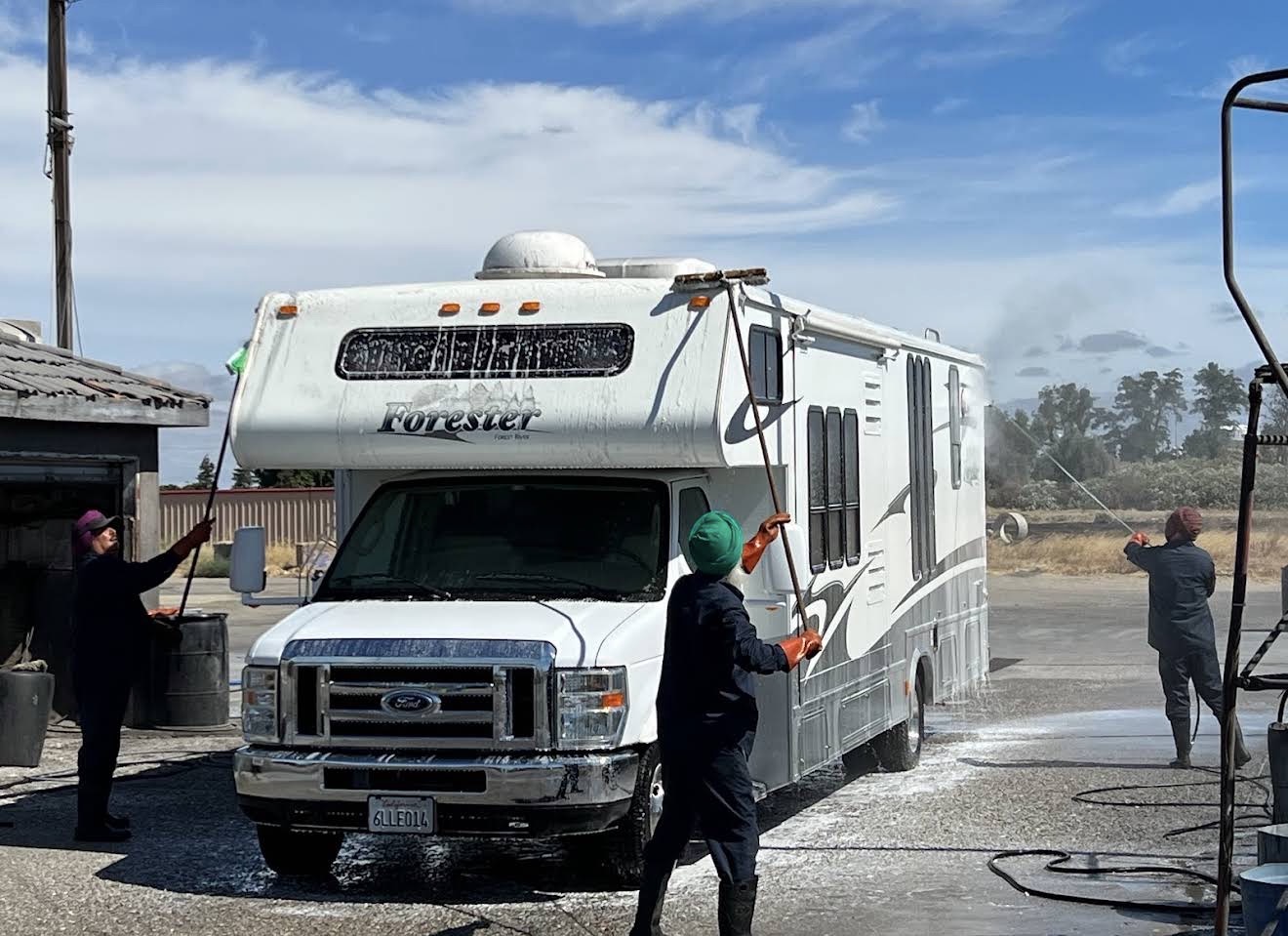 RV Forester motorhome being washed by crew