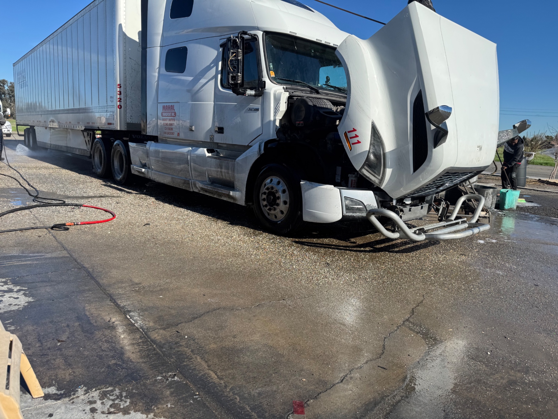 White Volvo semi with trailer getting full wash